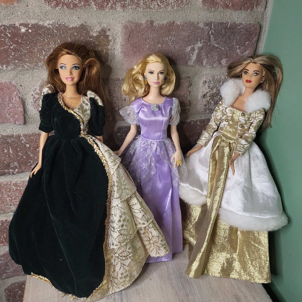3 Barbie dolls wearing different dresses